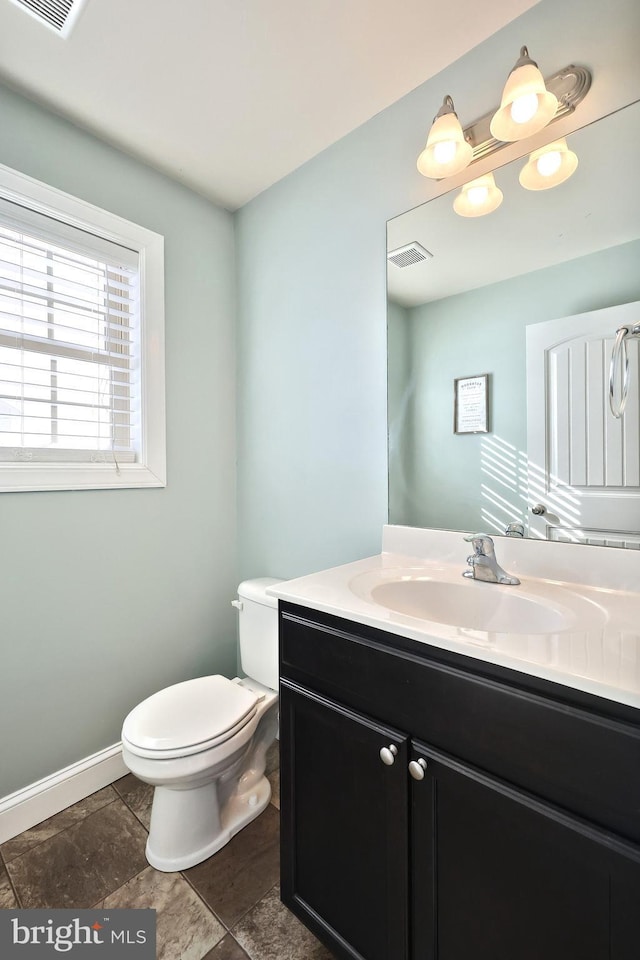 bathroom featuring toilet and vanity