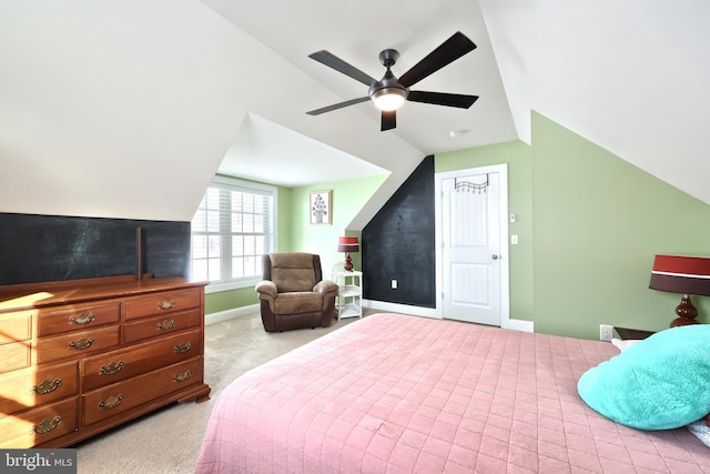 bedroom with ceiling fan, light colored carpet, a closet, and lofted ceiling