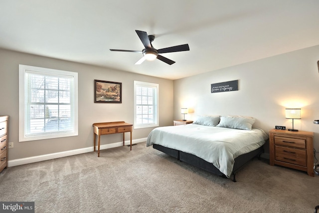 carpeted bedroom with ceiling fan and multiple windows