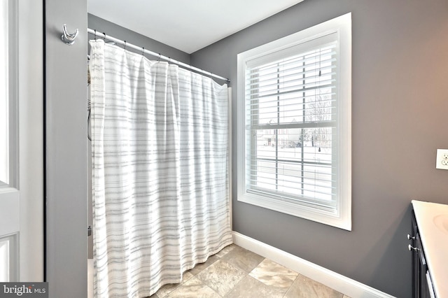 bathroom featuring vanity and curtained shower