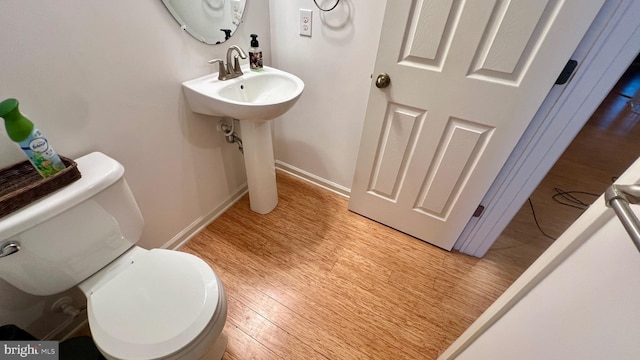 bathroom featuring toilet and hardwood / wood-style floors