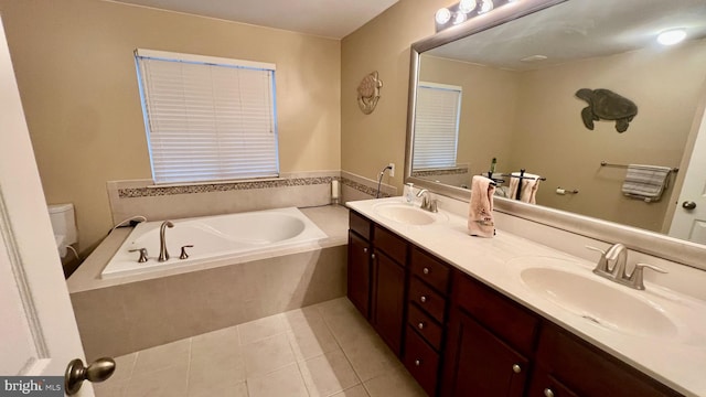 bathroom with toilet, vanity, tile patterned floors, and a relaxing tiled tub