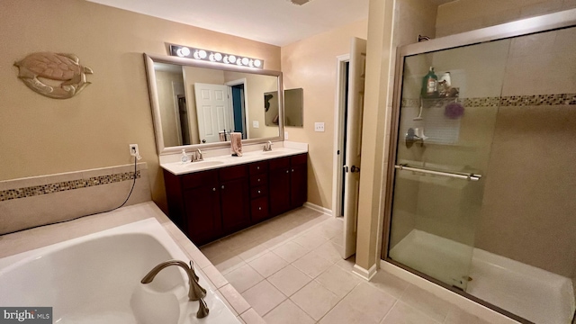 bathroom with tile patterned floors, vanity, and plus walk in shower