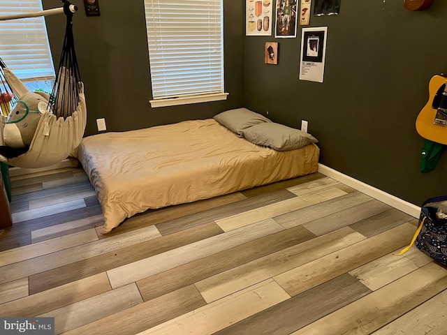 bedroom with hardwood / wood-style floors