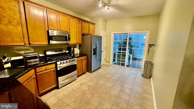 kitchen featuring light tile patterned floors and appliances with stainless steel finishes