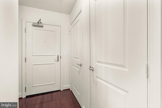 corridor with dark hardwood / wood-style floors