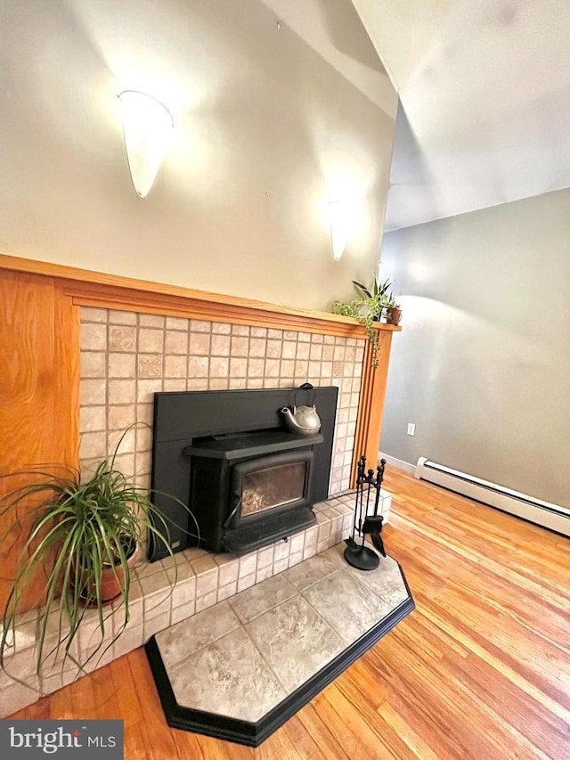 room details with a baseboard heating unit and hardwood / wood-style flooring