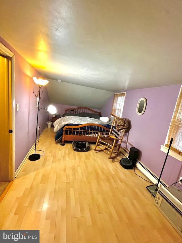 bedroom featuring wood-type flooring and vaulted ceiling