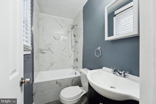 full bathroom featuring vanity, toilet, and tiled shower / bath