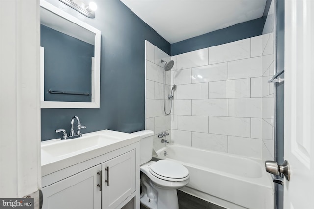 full bathroom with tiled shower / bath, vanity, and toilet