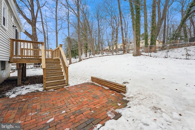 snowy yard featuring a deck