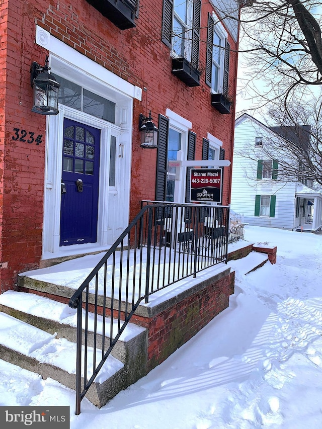 view of snow covered property entrance