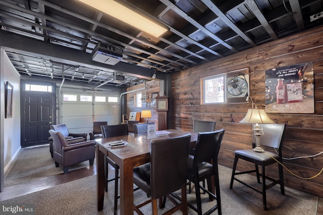 dining room with wood walls