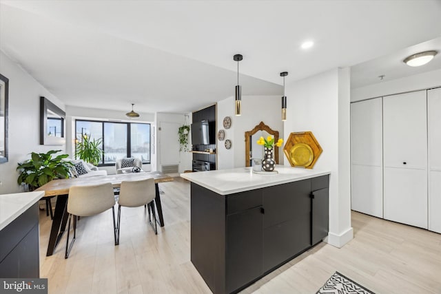 kitchen featuring light hardwood / wood-style flooring and hanging light fixtures