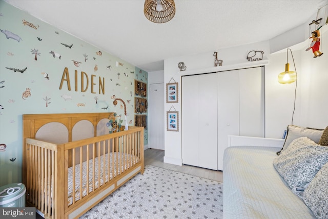 bedroom with a closet and a crib