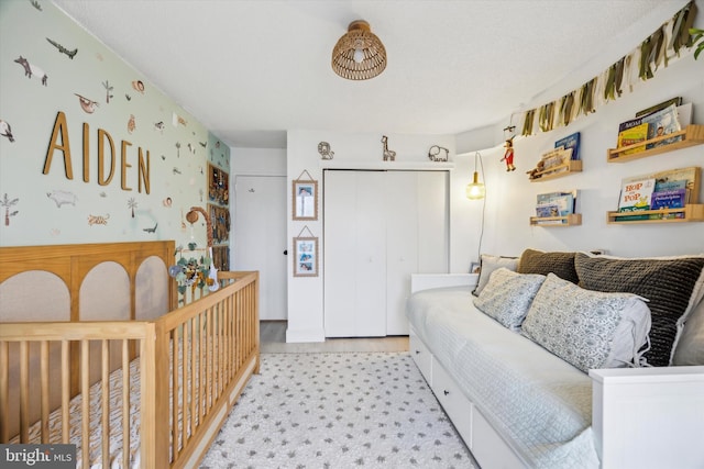 bedroom with a closet and a nursery area