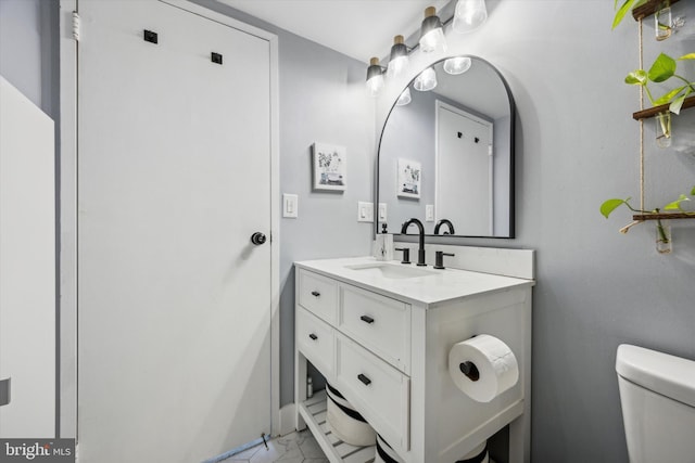 bathroom with toilet and vanity