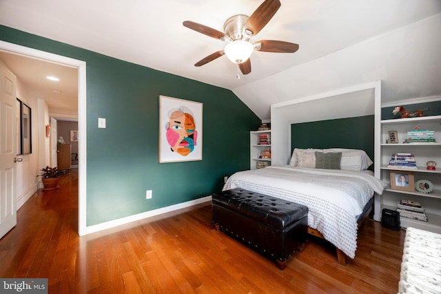 bedroom featuring ceiling fan, hardwood / wood-style floors, and lofted ceiling