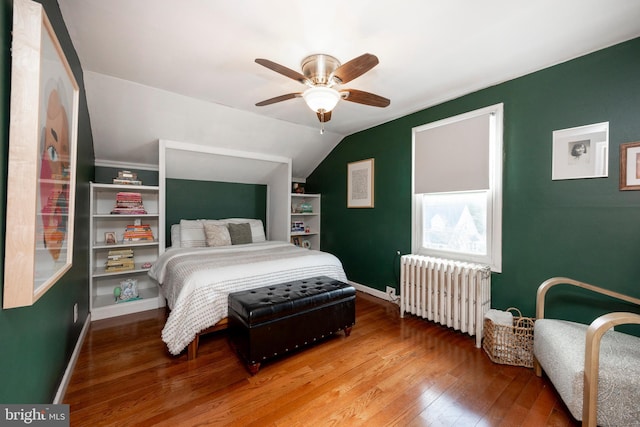 bedroom with radiator, ceiling fan, lofted ceiling, and hardwood / wood-style flooring