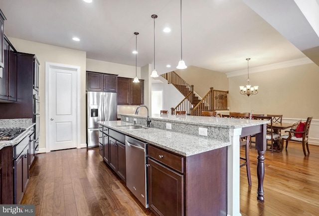 kitchen featuring a large island, pendant lighting, stainless steel appliances, and a breakfast bar area