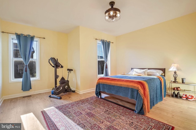 bedroom featuring hardwood / wood-style floors and multiple windows