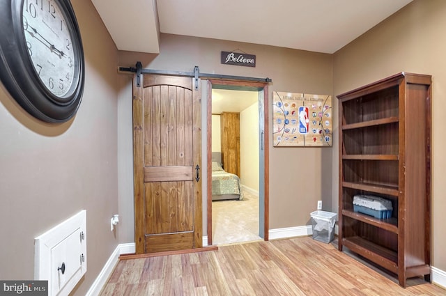 interior space with light hardwood / wood-style flooring and a barn door