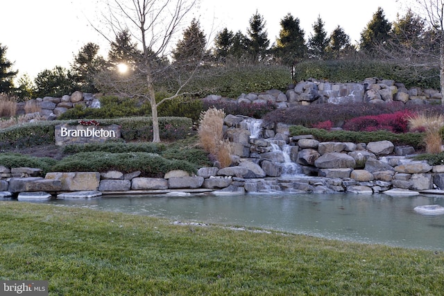 community sign featuring a small pond