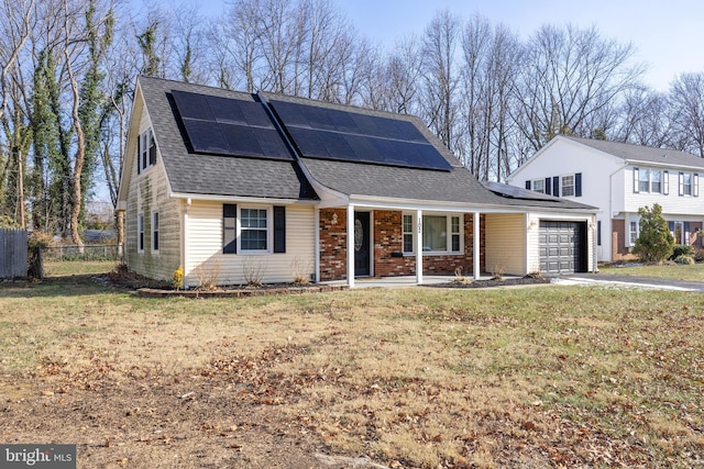 view of property with a front yard, a garage, and solar panels