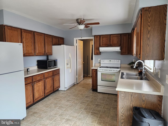 kitchen featuring ceiling fan, sink, and white appliances