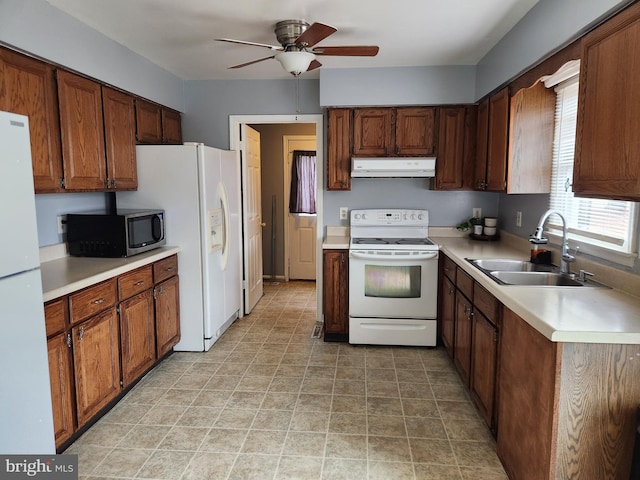 kitchen featuring ceiling fan, sink, and white appliances