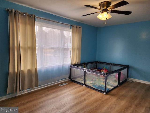 unfurnished bedroom featuring hardwood / wood-style flooring and ceiling fan