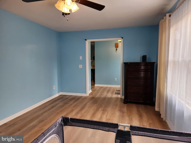 bedroom with ceiling fan and light wood-type flooring