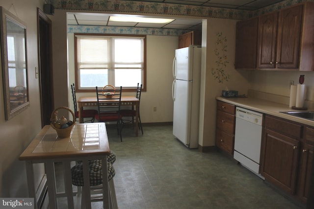 kitchen with dark brown cabinets and white appliances