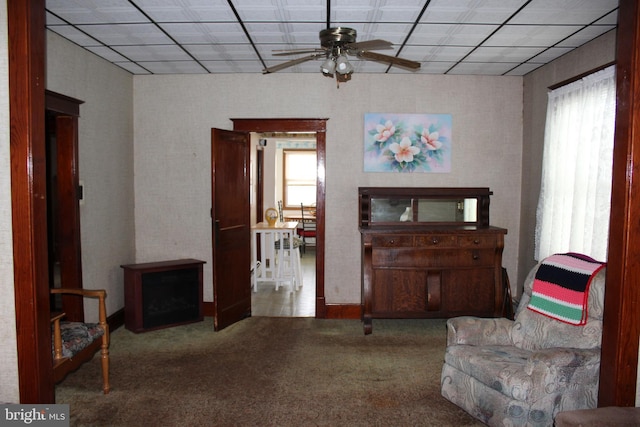 sitting room with ceiling fan, a healthy amount of sunlight, and carpet flooring