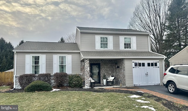 front facade featuring a garage and a front lawn