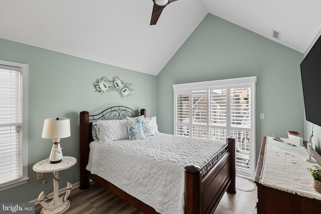 bedroom featuring ceiling fan, multiple windows, and hardwood / wood-style flooring