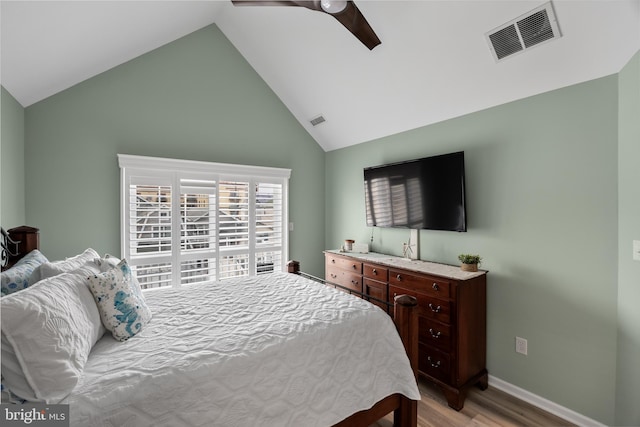 bedroom featuring ceiling fan, light hardwood / wood-style floors, and vaulted ceiling