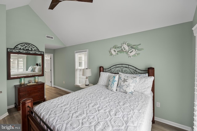 bedroom featuring ceiling fan, dark hardwood / wood-style floors, and high vaulted ceiling