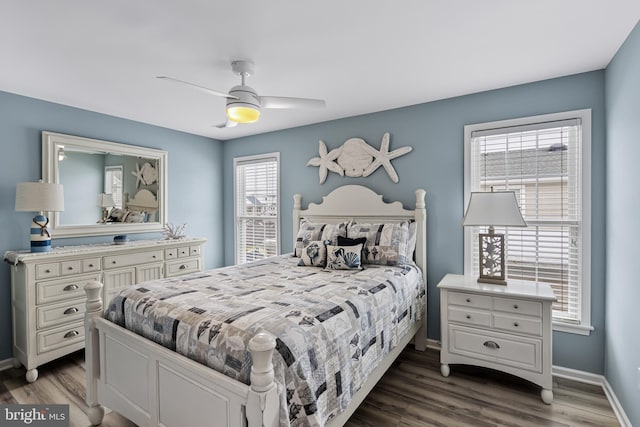 bedroom with ceiling fan and dark hardwood / wood-style floors