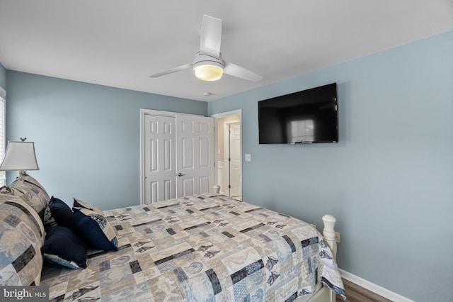 bedroom featuring ceiling fan, a closet, and wood-type flooring