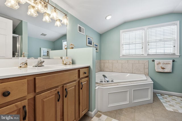 bathroom with independent shower and bath, lofted ceiling, tile patterned floors, and vanity