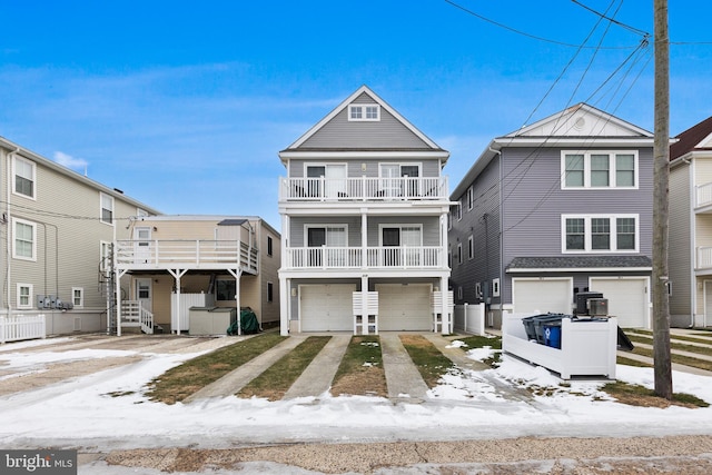 view of front of property featuring a garage and a balcony