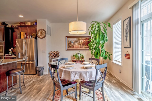 dining space featuring light hardwood / wood-style floors