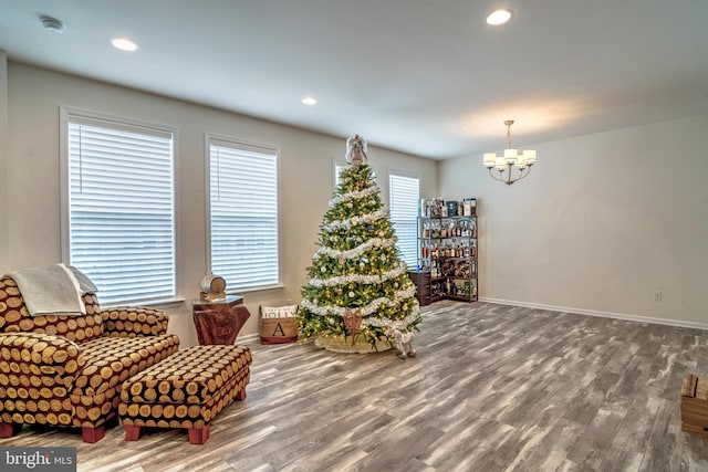 living area featuring an inviting chandelier and hardwood / wood-style floors