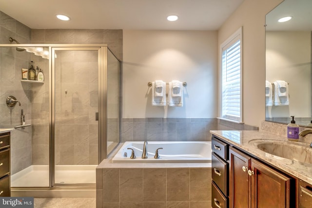 bathroom with separate shower and tub, plenty of natural light, and vanity