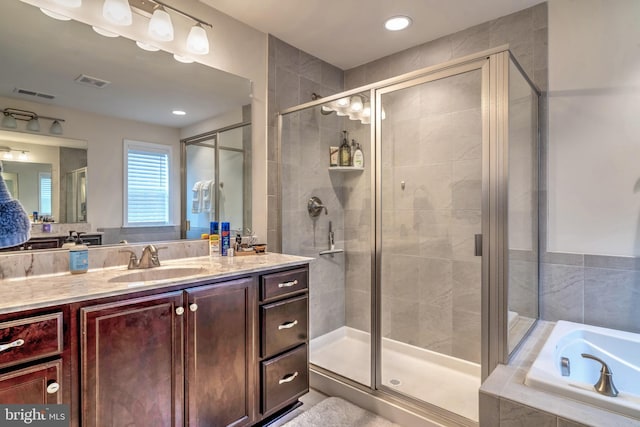 bathroom with plus walk in shower and vanity