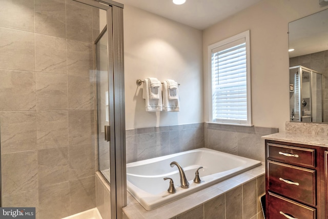 bathroom with vanity and plus walk in shower