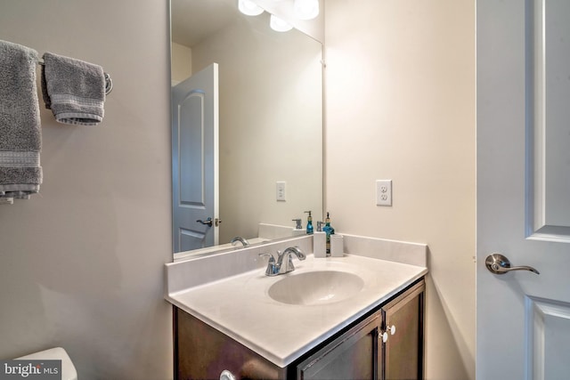 bathroom with toilet and vanity