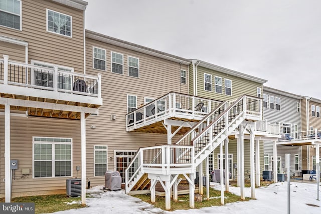 rear view of house with a deck and cooling unit