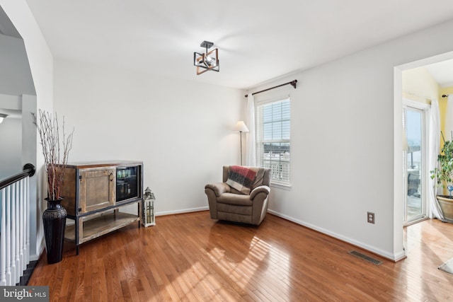 living area with hardwood / wood-style floors